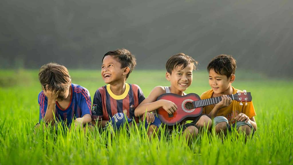 Happy kids playing ukulele