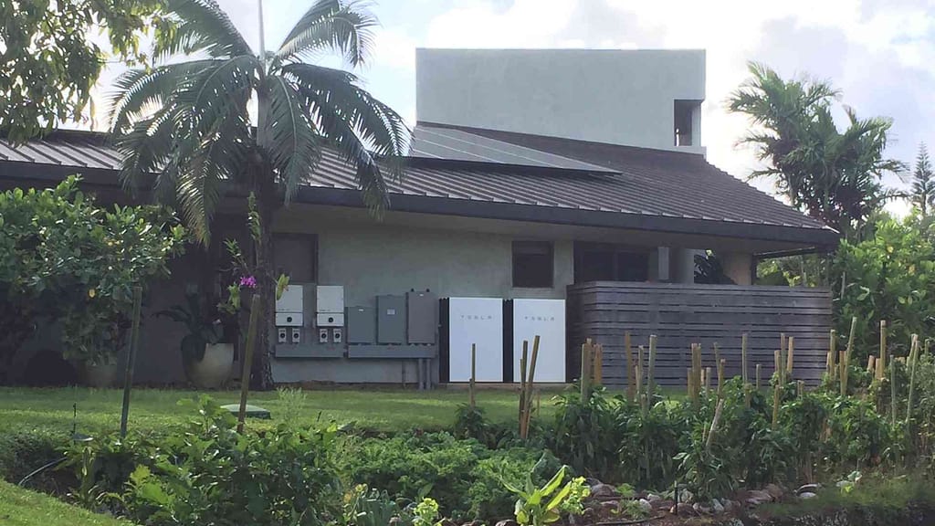 Tesla power wall on a home hawaii with garden