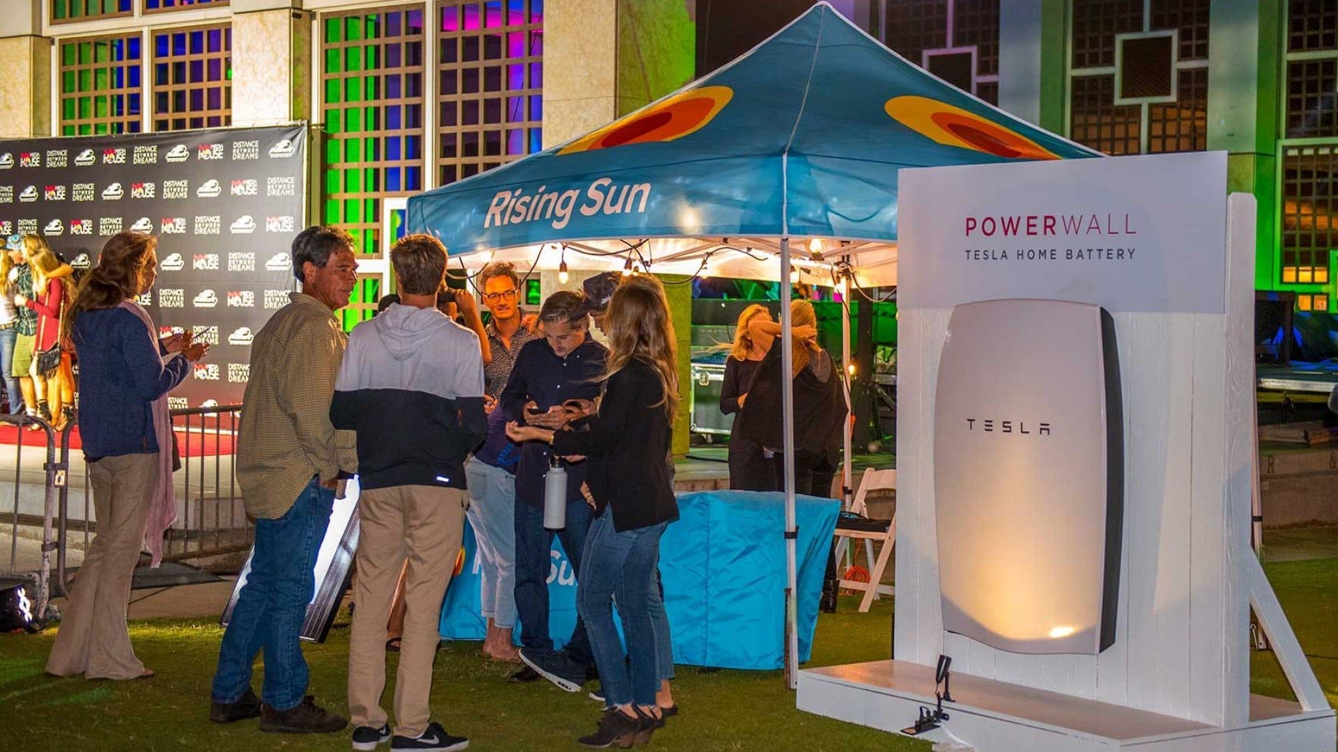 rising sun solar powerwall giveaway booth with people standing out front