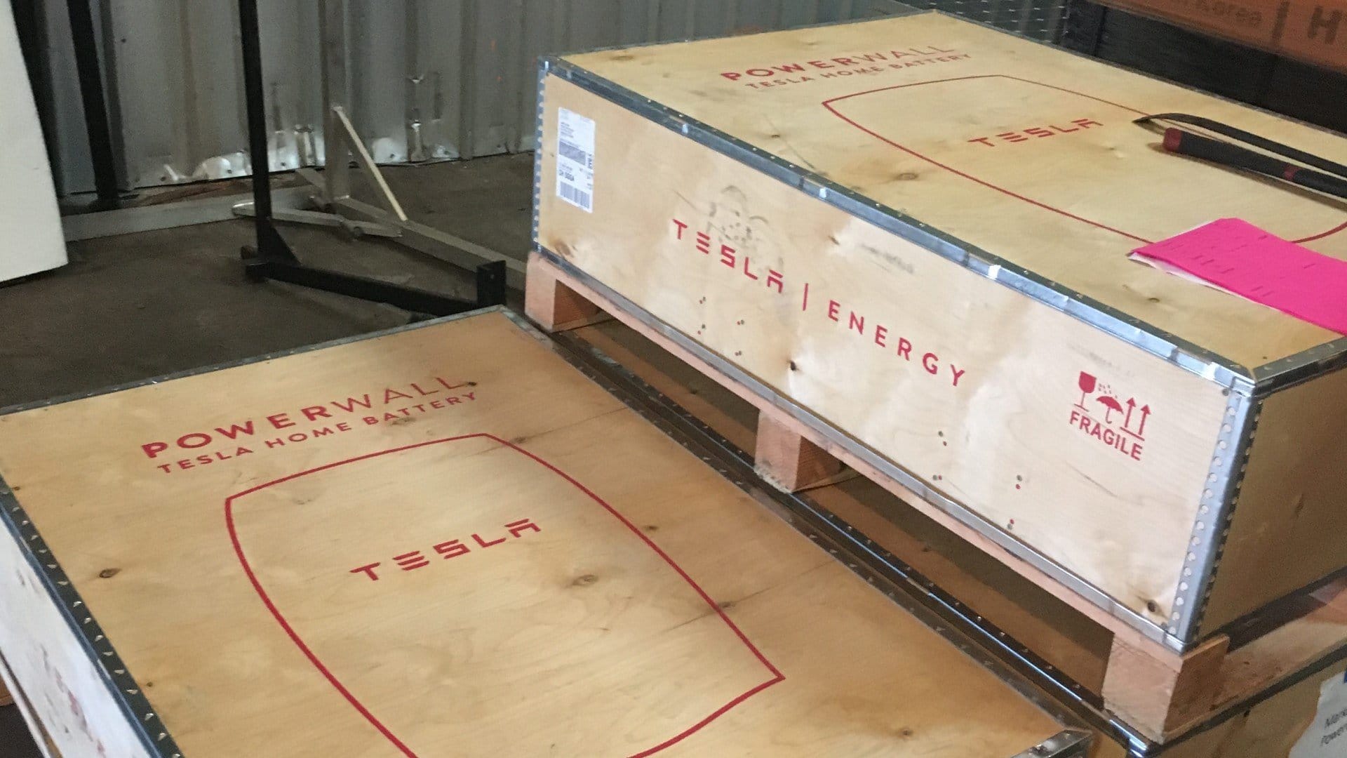 tesla powerwalls in their shipping boxes ariving at rising sun solars warehouse