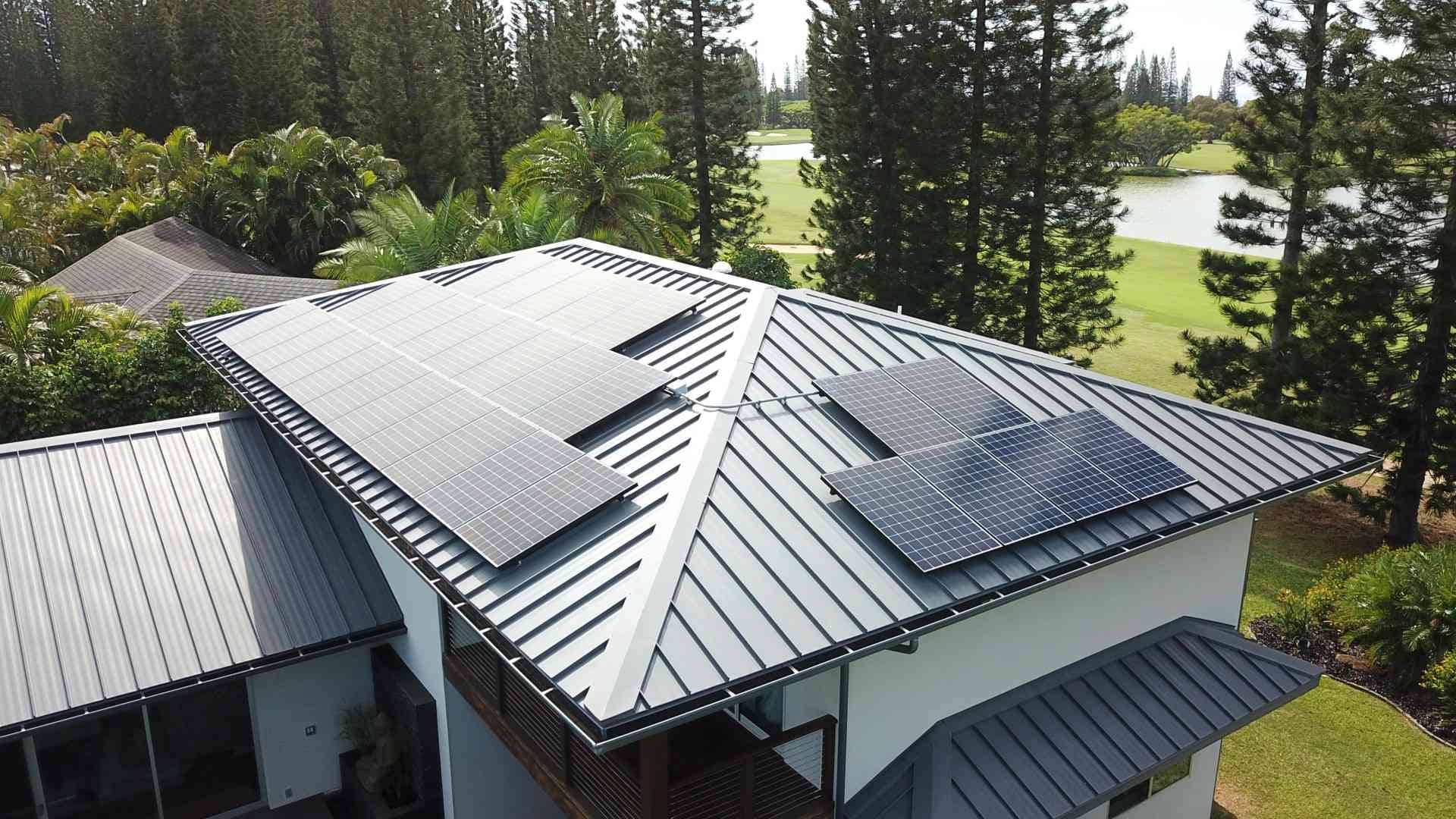 solar panels on a metal roof in Hawaii with pine trees